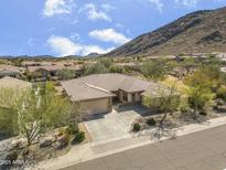 A lovely home is surrounded by beautiful desert landscape and the magnificent mountains beyond at 5721 W Molly Ln, Phoenix, AZ 85083