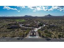 A gated community entrance featuring desert landscaping and mountain views at 9560 E Preserve Way, Scottsdale, AZ 85262