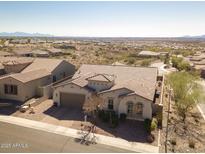 Suburban home showcasing tile roof, desert landscaping and attached garage at 10249 W Redbird Rd, Peoria, AZ 85383