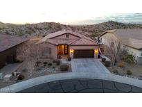 Exterior front view of a well-maintained home with a landscaped yard and three-car garage at 12008 S 186Th Dr, Goodyear, AZ 85338