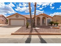 Charming home with a well-maintained desert landscape, palm trees, and a two-car garage at 1549 E Westchester Dr, Chandler, AZ 85249