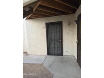 Exterior view of the unit's secure front door with a covered walkway, and easy access to parking at 16402 N 31St St # 117, Phoenix, AZ 85032