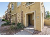Charming townhome with textured stucco, brick accents, and desert landscaping providing curb appeal at 18250 N Cave Creek Rd # 164, Phoenix, AZ 85032