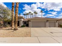 Charming single-story home with a three-car garage and manicured desert landscaping, perfect for low-maintenance living at 20029 N Coronado Ridge Dr, Surprise, AZ 85387