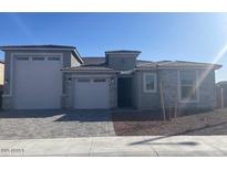 Charming single-story home featuring a three-car garage, stone accents, and a well-maintained front yard at 20285 W Monterey Way, Buckeye, AZ 85396