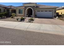 Charming single-story home features stone accents, a tiled roof and a two car garage at 24986 N 172Nd Ln, Surprise, AZ 85387