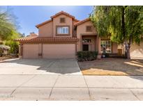 Two-story home featuring a three car garage, desert landscaping, and a beautiful terracotta roof at 4643 E Villa Maria Dr, Phoenix, AZ 85032