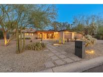 Charming single-story home featuring a well-maintained xeriscaped front yard and two-car garage at 5507 N Calle Del Santo --, Phoenix, AZ 85018