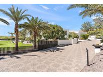 Stunning home exterior showcasing lush landscaping, a long driveway, and modern architectural design at 6216 N 38Th Pl, Paradise Valley, AZ 85253