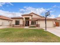 Charming single-story home with a well-manicured lawn, tile roof, and neutral stucco exterior at 7235 W Dreyfus Dr, Peoria, AZ 85381