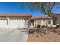 Inviting single-story home with a two-car garage, neutral stucco, and xeriscaped front yard at 10960 E Monte Ave # 164, Mesa, AZ 85209
