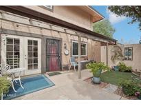 Charming covered patio area with outdoor seating, potted plants, and pleasant ambiance at 1144 N 85Th Pl, Scottsdale, AZ 85257