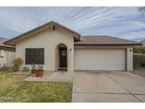 Charming single-story home with a two-car garage and a welcoming front entrance at 12243 S Chippewa Dr, Phoenix, AZ 85044