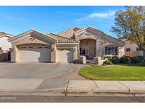 Charming single-story home featuring a three-car garage and well-manicured lawn in a desirable community at 20331 N Fletcher Way, Peoria, AZ 85382