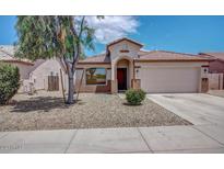 Charming single-Gathering home featuring a two-car garage, red tile roof, and desert landscaping at 25766 W Valley View Dr, Buckeye, AZ 85326