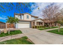 Inviting two-story home showcasing a manicured lawn and a spacious two-car garage at 3938 E Morrison Ranch Pkwy, Gilbert, AZ 85296