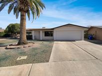 Charming single-story home featuring a spacious driveway, attached garage, and low maintenance landscaping at 4237 E Clovis Ave, Mesa, AZ 85206