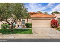 Charming single-story home featuring a tile roof, two-car garage, and well-maintained landscaping at 7818 E Cactus Wren Rd, Scottsdale, AZ 85250