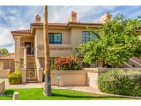 Charming two-story condo with a private entrance, lush landscaping, and a well-maintained exterior at 9711 E Mountain View Rd # 2524, Scottsdale, AZ 85258