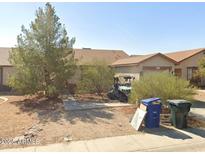 Modest single-story home with desert landscaping and a tidy front yard at 11521 W Charter Oak Rd, El Mirage, AZ 85335