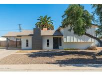 Charming single-Gathering home featuring a gray painted chimney and a covered front porch at 13807 N 33Rd Dr, Phoenix, AZ 85053