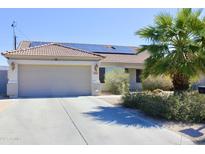 Charming single-story home with a two-car garage, solar panels, and desert landscaping at 16243 N 27Th St, Phoenix, AZ 85032