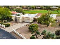 Charming single-story home with a two-car garage, desert landscaping, and a golf course view at 18833 E Latigo Ln, Rio Verde, AZ 85263