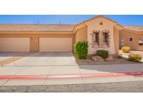 Charming home exterior featuring a three car garage, desert landscaping, and stone facade detailing at 2565 S Signal Butte Rd # 8, Mesa, AZ 85209