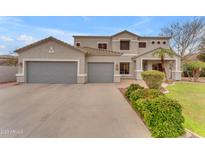 Charming two-story home featuring a two-car garage, desert landscaping and mature palm trees at 2688 S Racine Ct, Gilbert, AZ 85295