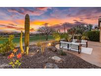 Relaxing outdoor patio features comfortable seating, desert landscaping, and stunning sunset views at 28516 N 128Th Dr, Peoria, AZ 85383