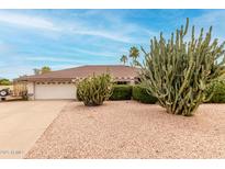 Charming single-story home with a two-car garage, desert landscaping, and beautiful cactus accents at 4705 W Annette Cir, Glendale, AZ 85308