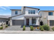 Stunning two-story home featuring a gray garage door, modern design, and desert landscaping at 6735 N 9Th Dr, Phoenix, AZ 85013