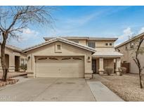 Charming two-story home with a well-maintained front yard and two car garage at 7413 N 67Th Dr, Glendale, AZ 85303