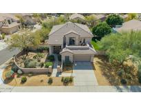 Stunning two-story home with a tile roof, well-manicured landscaping, and a spacious driveway at 7693 E Via Del Sol Dr, Scottsdale, AZ 85255