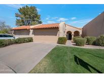 Charming home featuring a red tile roof, well-manicured lawn, and welcoming front entrance with a private garage at 924 W Boxelder Pl, Chandler, AZ 85225