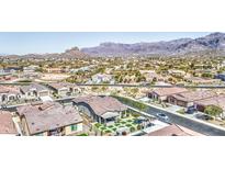 Expansive aerial view of a charming neighborhood showcasing beautiful homes and stunning mountain views at 12043 E Amanda Rd, Gold Canyon, AZ 85118