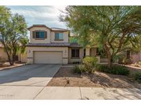 Charming two-story home with a well-manicured lawn and a two-car garage at 12509 W Whyman St, Avondale, AZ 85323