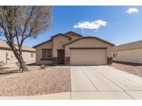 Charming single-Gathering home with neutral stucco, desert landscaping and an attached two car garage at 1375 S 225Th Ln, Buckeye, AZ 85326