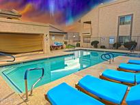 Sparkling community pool with comfortable lounge chairs, perfect for relaxation and leisure at 145 N 74Th St # 256, Mesa, AZ 85207