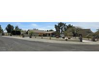 Charming single-story home boasts a covered parking area, desert landscaping, and manicured greenery at 18224 N 70Th Ave, Glendale, AZ 85308