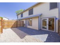 Fenced backyard features a patio with both gray stone and gravel, creating a cozy outdoor space at 2455 E Broadway Rd # 102, Mesa, AZ 85204