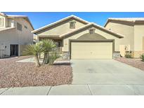 Beige single-story home featuring low maintenance landscaping and a two car garage at 4050 E Agave Rd, Phoenix, AZ 85044