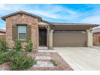 Charming single-story home with a stone facade and a well-maintained front yard at 4135 E Sagebrush St, Gilbert, AZ 85296