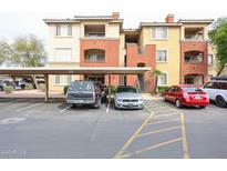 Apartment complex exterior with covered parking and several parked cars, landscaped with trees at 5401 E Van Buren St # 2095, Phoenix, AZ 85008