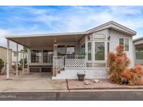 Charming mobile home featuring a covered porch, well-maintained landscaping, and a cozy exterior at 7750 E Broadway Rd # 843, Mesa, AZ 85208