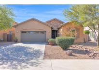 Charming single-story home with a well-manicured front yard and a two-car garage at 913 E Tekoa Ave, Gilbert, AZ 85298