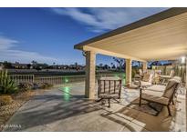 Spacious covered patio features elegant seating, stone columns, and scenic golf course views at 9409 W Taro Ln, Peoria, AZ 85382