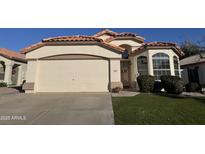 Charming single-story home featuring a two-car garage, desert landscaping, and a welcoming front entrance at 9632 W Runion Dr, Peoria, AZ 85382