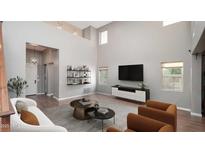 Bright living room boasts soaring ceilings, modern shelving, and stylish contemporary furnishings at 13346 W Jesse Red Dr, Peoria, AZ 85383
