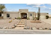 Southwest-style home featuring desert landscaping, a stone fountain, and a covered front porch at 15440 E Mustang Dr, Fountain Hills, AZ 85268